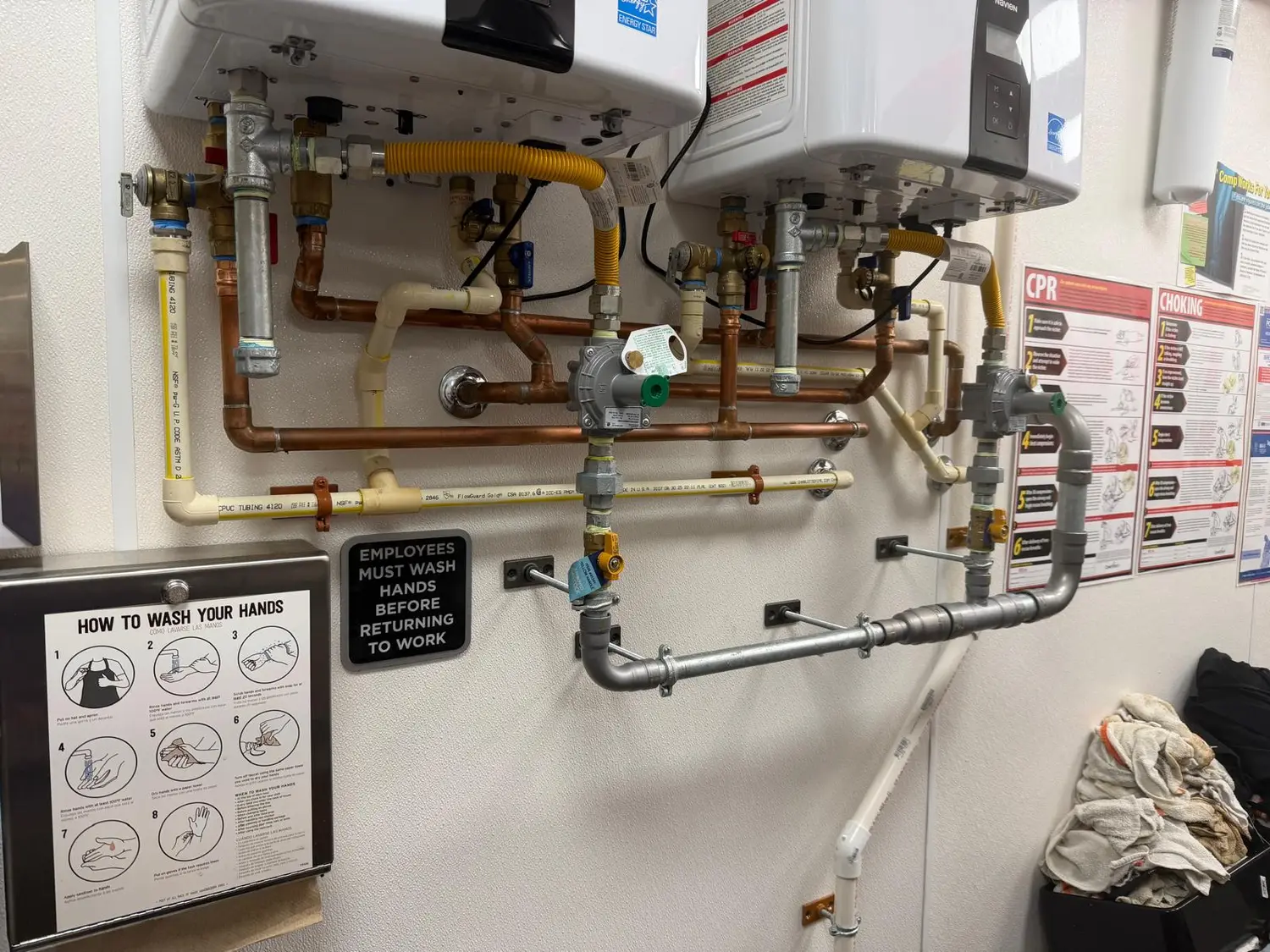 Commercial gas piping and copper water lines installed in a kitchen mechanical wall